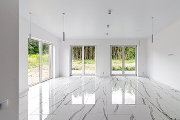 Interior of empty apartment, wide room with marble floor