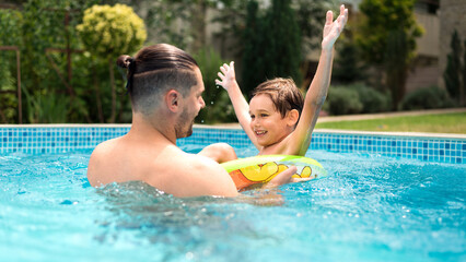 Dad and son in the pool