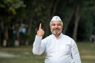 indian man showing finger after voting. voting sign in india