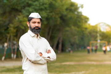 Indian or marathi man in traditional wear and giving expression at park.