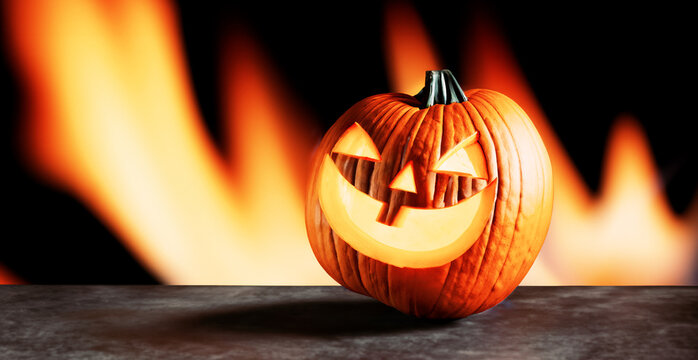 immagine con primo piano di zucca intagliata e illuminata per la festa di Halloween, sfondo spettrale con lingue di fuoco