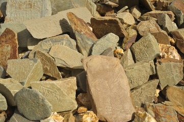 Engraved stones with Tibetan Buddhist mantra in a village of Padum, Zanskar Valley, Ladakh, INDIA 