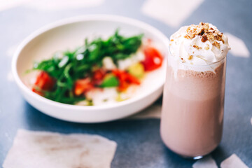 milk drink on a coffee shop flyer. refreshing glaze with ice on the cafe table. summer cold drink with cream