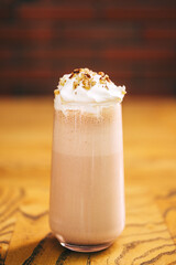 milk drink on a coffee shop flyer. refreshing glaze with ice on the cafe table. summer cold drink with cream