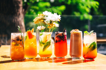 soft drinks on the summer coffee shop. refreshing sweet drinks with ice on the cafe table. summer cold drinks of different taste