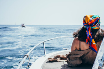 Woman enjoying the sun on a boat
