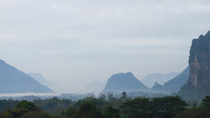 Landscape Panorama view Entire mountain covered in mist during the morning at Vang Vieng, Laos. 