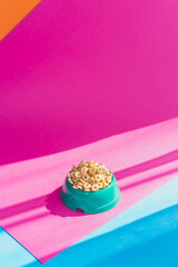 Cereals corn flakes or rings in a bowl on pink and blue background, flat lay - 630642599