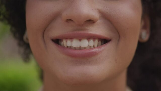 Extreme Close Up of Female Toothy Smile Outdoors