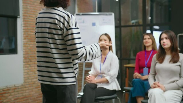 The female businesswoman is seen conversing with her team in a contemporary office setting, passionately describing her work at meeting room.