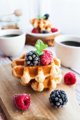 Belgian waffles with berries. Morning. On a wooden background