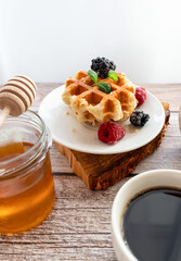 Belgian waffles with berries. Morning. On a wooden background