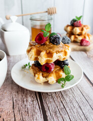 Belgian waffles with berries. Morning. On a wooden background