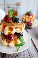 Belgian waffles with berries. Morning. On a wooden background