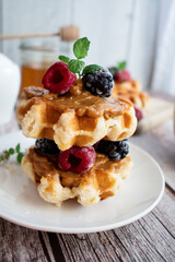 Belgian waffles with berries. Morning. On a wooden background
