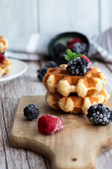 Belgian waffles with berries. Morning. On a wooden background