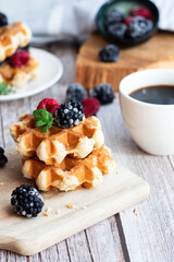 Belgian waffles with berries. Morning. On a wooden background