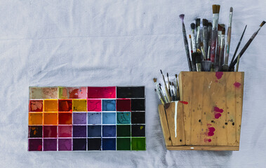 artist palette with brushes on white background