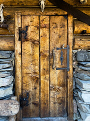 old wooden door of a mountain log cabin