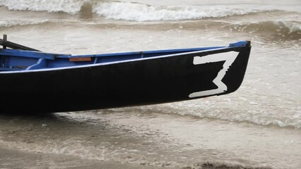 Closeup of taped number three on currach boat canoe, galway ireland
