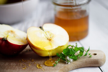 honey with apples and honey. on a white table