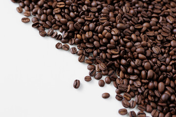 Roasted black coffee beans on white background