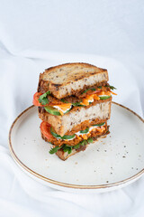 Vegan sandwich with carrot, tomatoes and cucumbers
