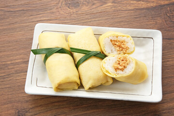 Semar Mendem, made from sticky rice with shredded chicken, wrapped in an omelette or crepe. Indonesian traditional food

