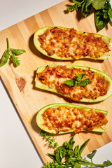 Stuffed zucchini on white background, baked loaded zucchini boats, Top view, Homemade.