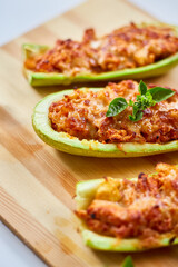 Stuffed zucchini on white background, baked loaded zucchini boats, Top view, Homemade.