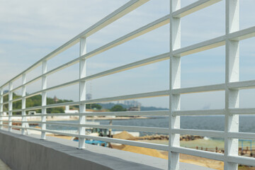 Sea embankment, white handrails on the seashore