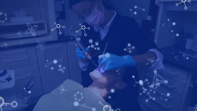 Animation of network of molecules over biracial female dentist and female patient