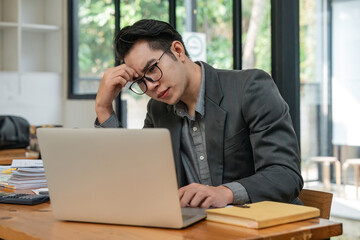 Business man from work stress concept. asian man feeling tired suffering using computer working work place