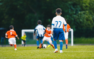 Young school boys playing soccer game. European soccer match between youth teams. Junior...