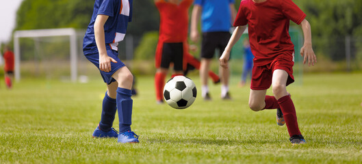 Young Football Players Kicking Ball on Soccer Field. Soccer Horizontal Background. Youth Junior...