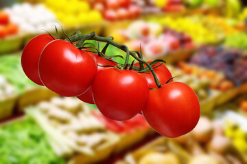tomatoes on vine against the backdrop of a grocery store counter - 630674308