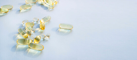 Omega 3 fish oil gel capsules, vitamin E. Close-up medicine yellow transparent pills, omega 3 fish...
