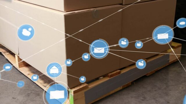 Animation of connected envelope and speech bubble icons over cardboard boxes on pallet in warehouse