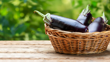 eggplant in a wicker basket on wooden table with blurred green background
