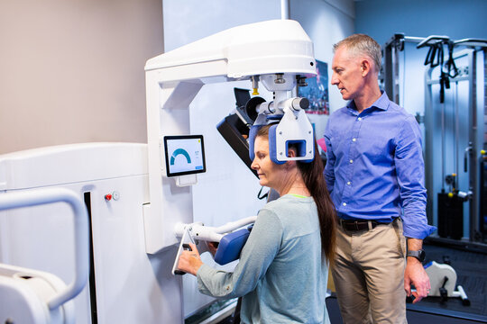 Physiotherapist talking with client using physio equipment