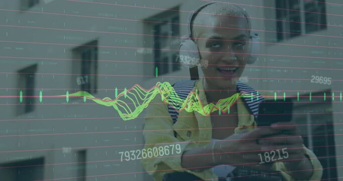 Animation of graphs, numbers, biracial woman wearing headphones listening to music on cellphone