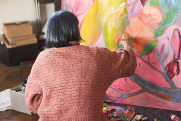 Female artist drawing painting with paint brush and paint. Creating modern Art