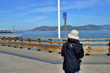 Pier39 San Francisco, California, USA - April 21, 2023. Traveller looking the nice San Fransisco bay scenery.