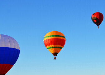 Three balloons against a blue sky