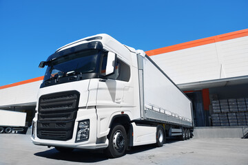 white truck loading in front of the warehouse