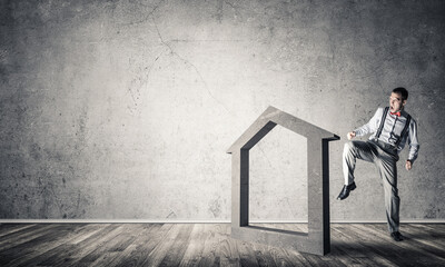 Stone home silhouette in empty room as symbol for real estate insurance