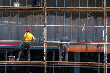 Workers on scaffolding at a construction site