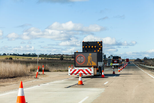40 roadwork sign on side of highway with road cones