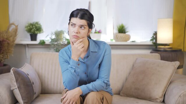 Young woman looking thoughtfully at camera.