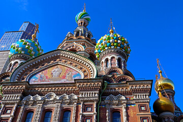 Fototapeta na wymiar Exterior of Church of the Savior on Blood with ornate domes against blue sky. Outside view of architecture of famous Russian Temple and museum. Saint Petersburg, Russia.